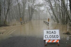 flooded street with Road Closed sign